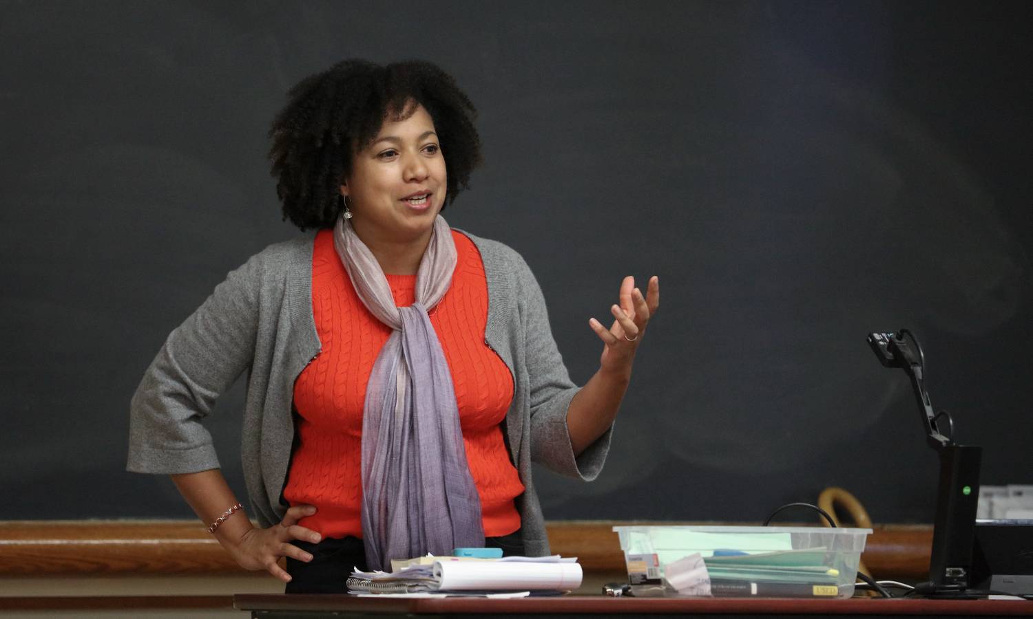 Prof. Nicola Minott-Ahl teaches in front of a blackboard.