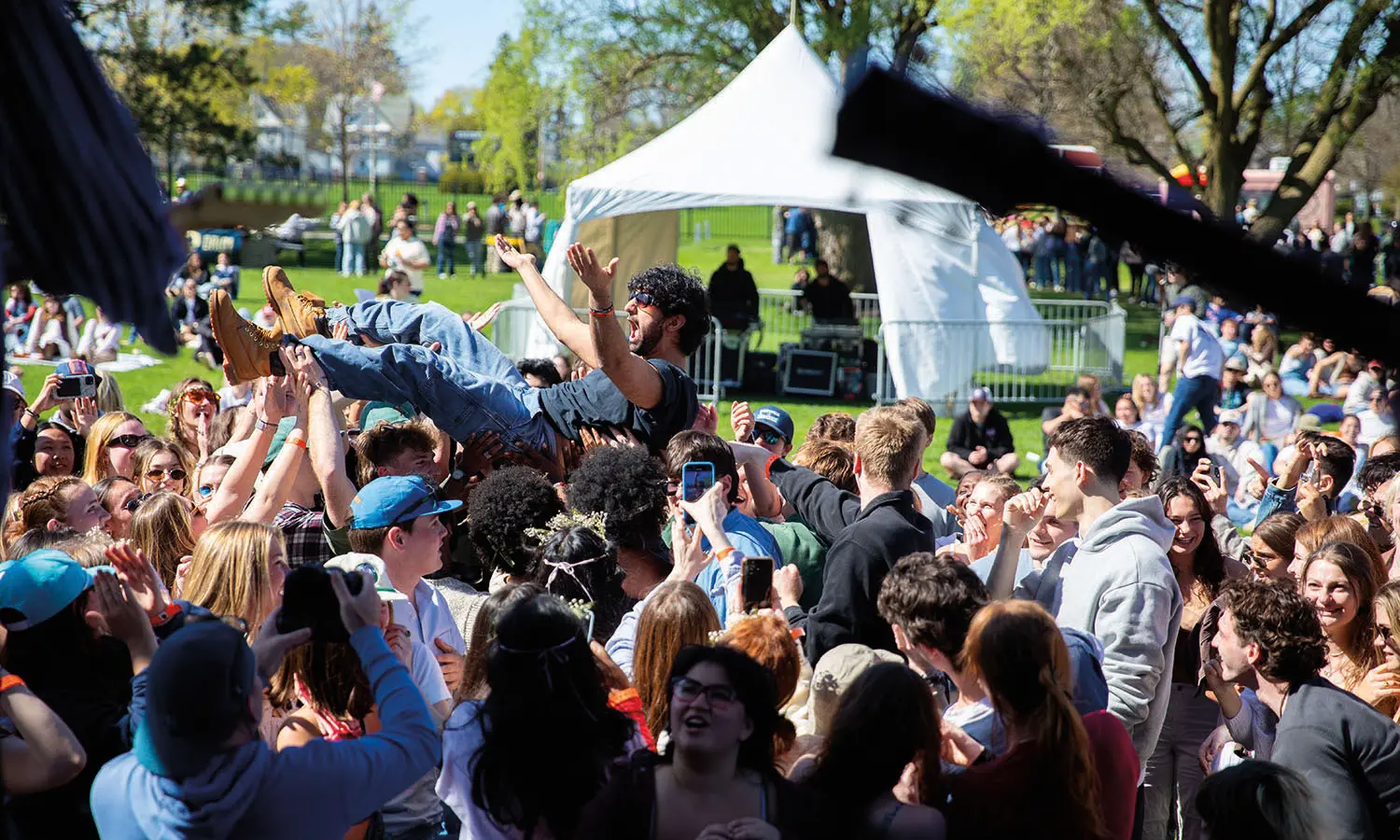 A student is lifted above the crowd during Folk Fest