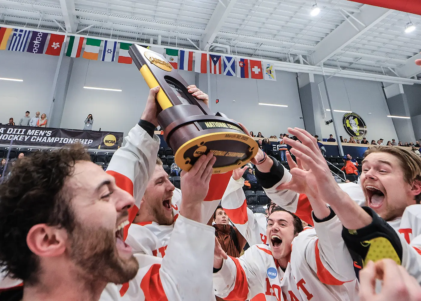 The Hobart hockey team celebrates with their third-straight national championship trophy in 2025