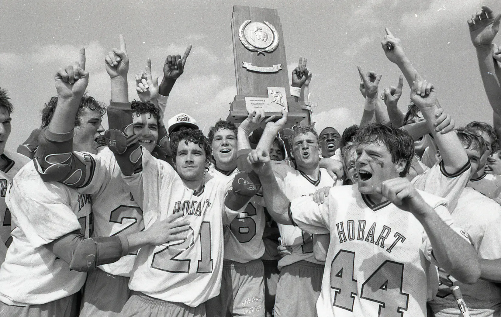 The 1986 Hobart lacrosse team celebrates the fifth consecutive NCAA Division III title