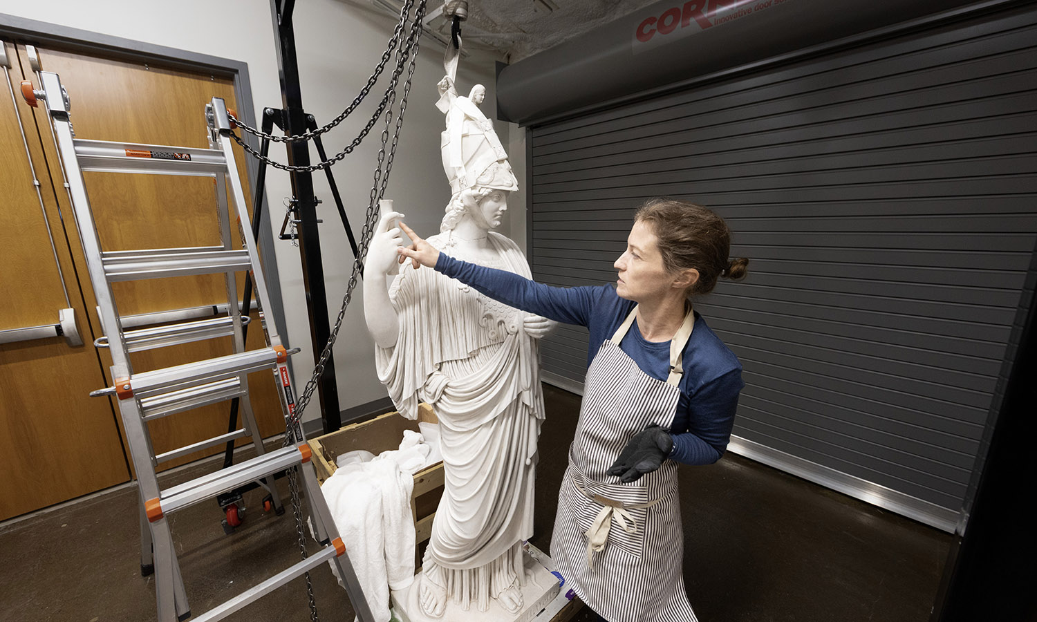 A cylindrical object was among the broken pieces Wells College officials had kept for decades with the hope they someday would help restore Minerva. Through research, Paige Isaacs discovered the cylinder was in fact a scroll, symbolizing learning. 