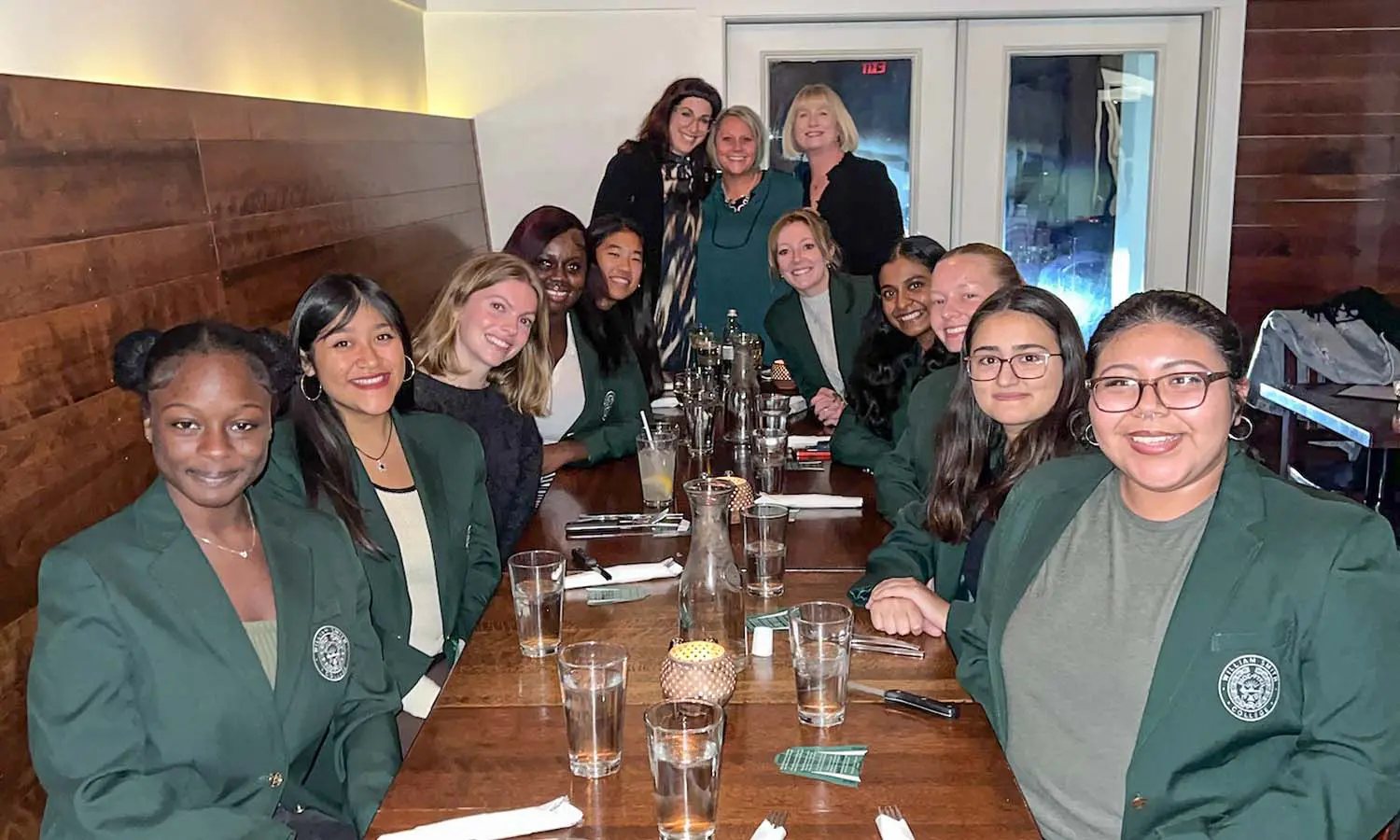 Members of the Hai Timiai Honors Society gather with Senior Associate Dean Kelly Payne, Assistant to the Deans Gretchen Emerick-Marr and Assistant Dean Amy Green before dinner at Ports Cafe.