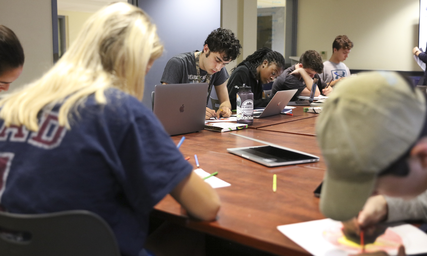 Students work on drawing symbols for Kristen Welsh's FSEM 