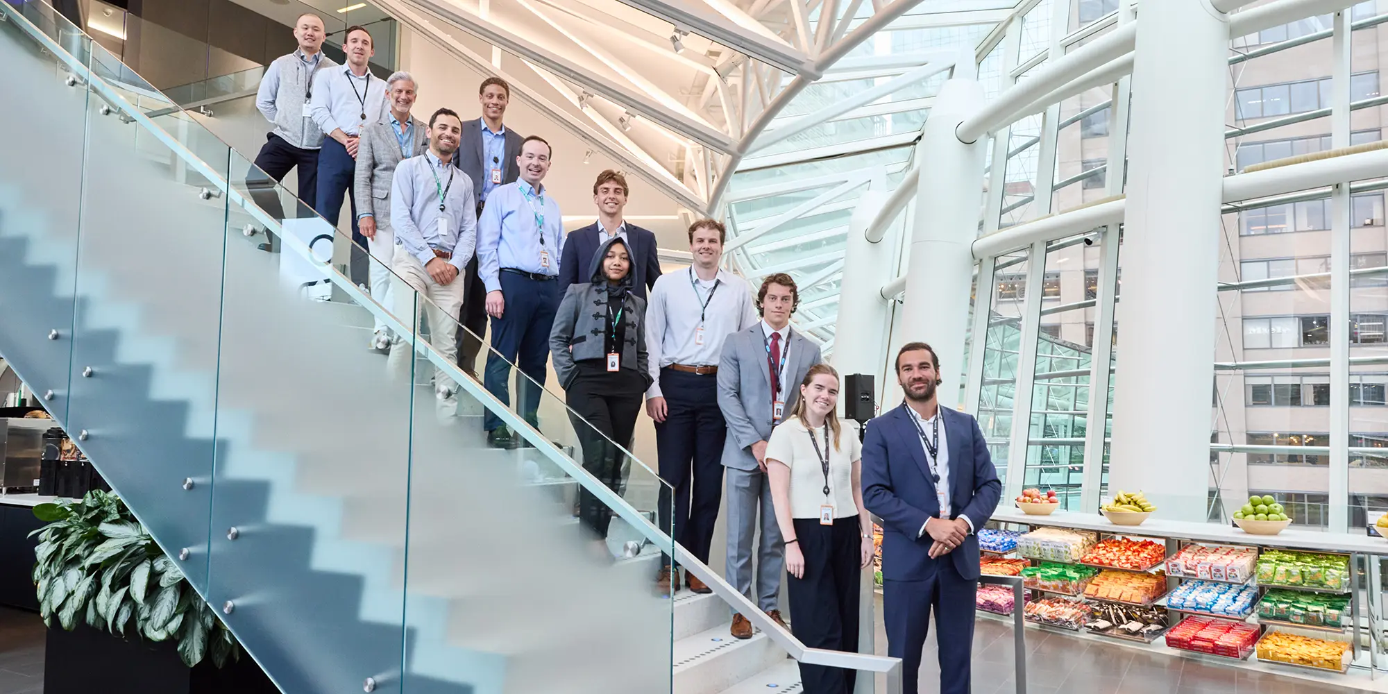 Students and staff on a staircase in the glass atrium of the Bloomberg offices in New York