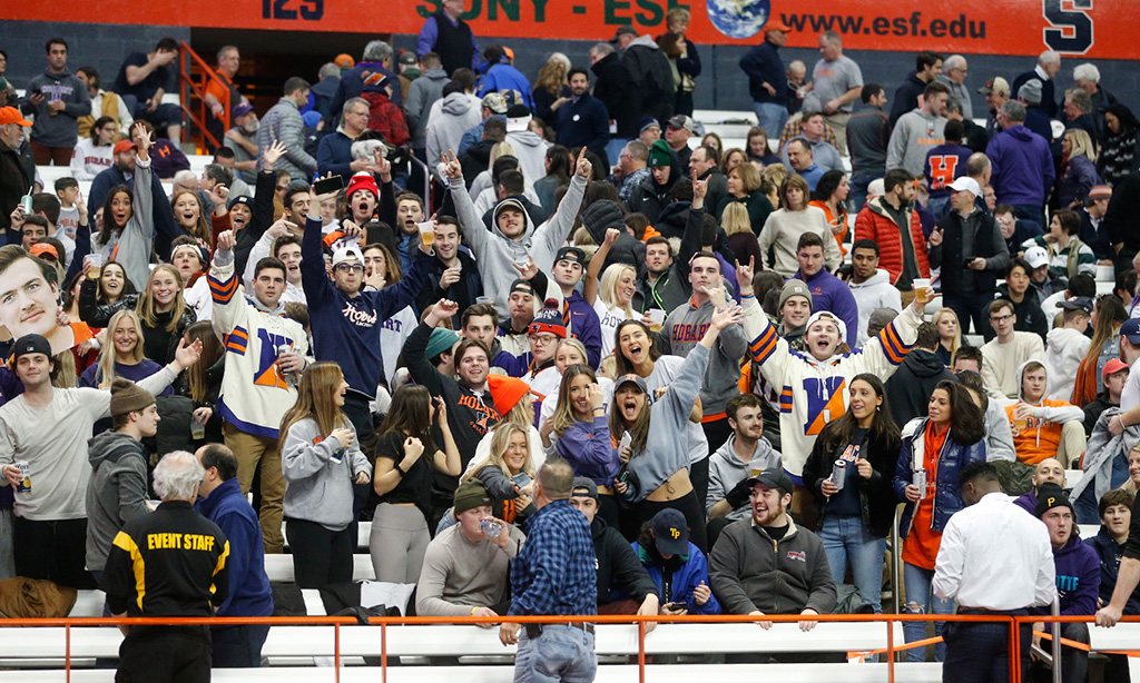 A crowd of students cheer on the Statesmen Lacrosse team.