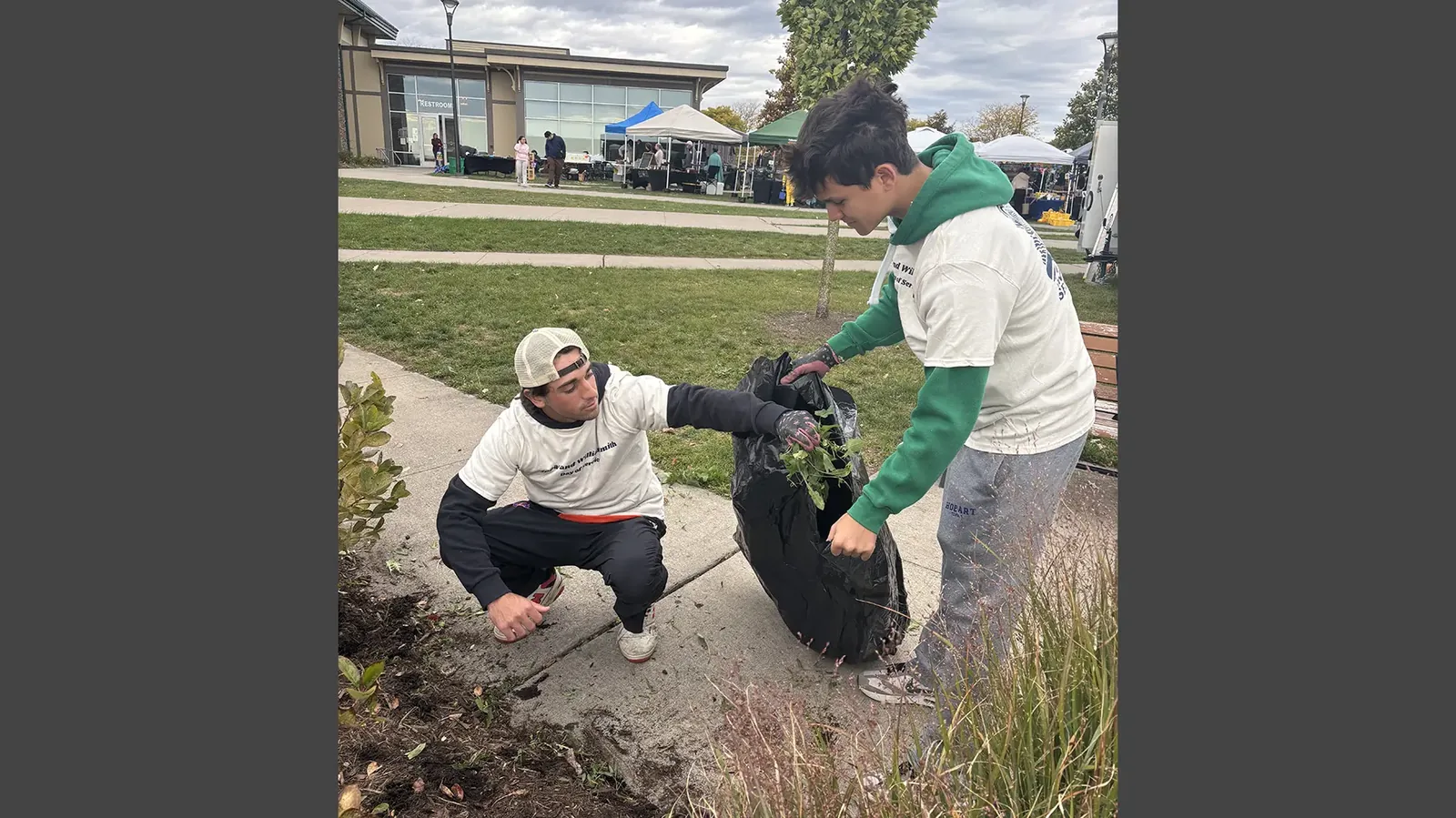 Student-athletes pull weeds during the HWS Day of Service