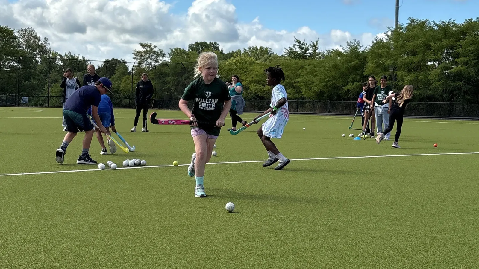 A young player runs a drill at a William Smith field hockey youth clinic