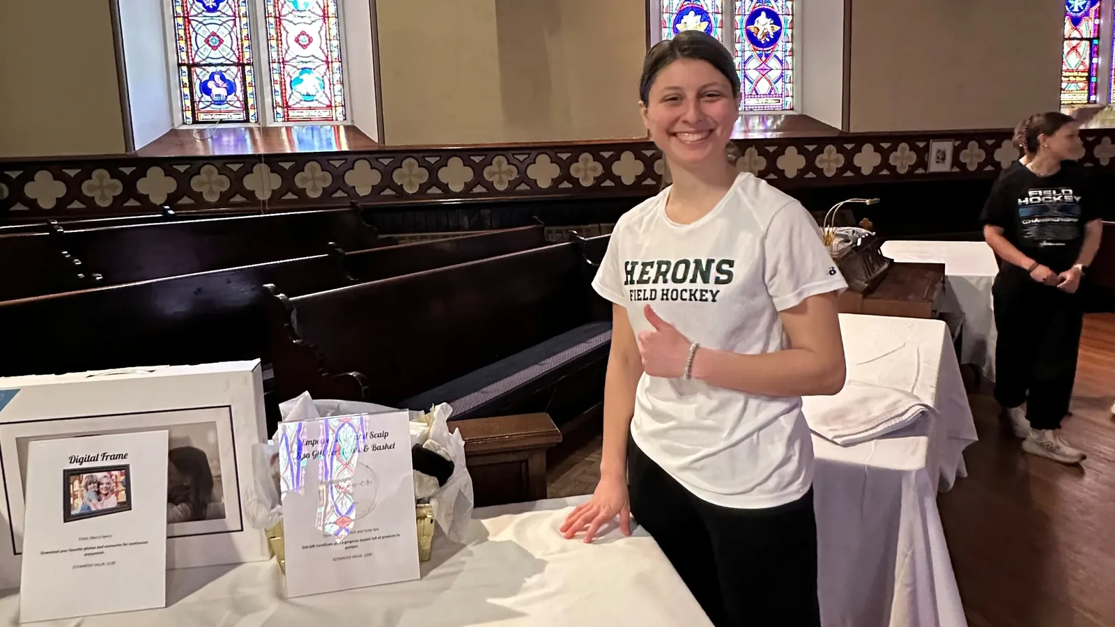 A William Smith field hockey student-athlete at a community fundraiser event