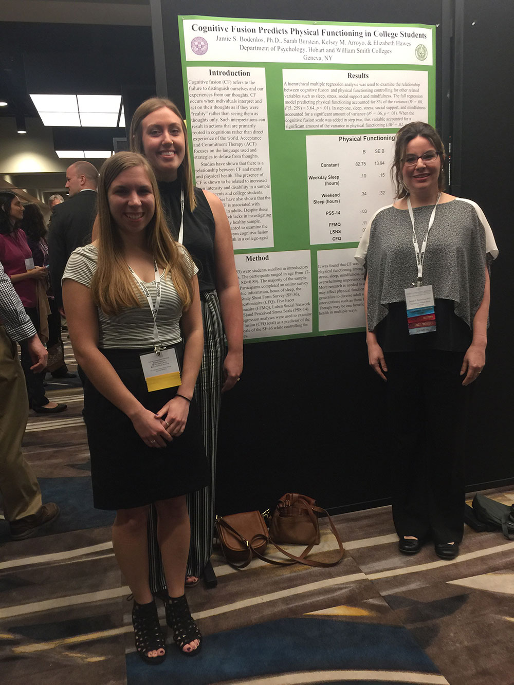 Bodenlos and students in front of poster