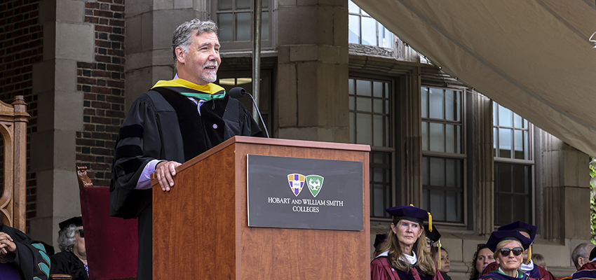 Beyer speaks at the podium