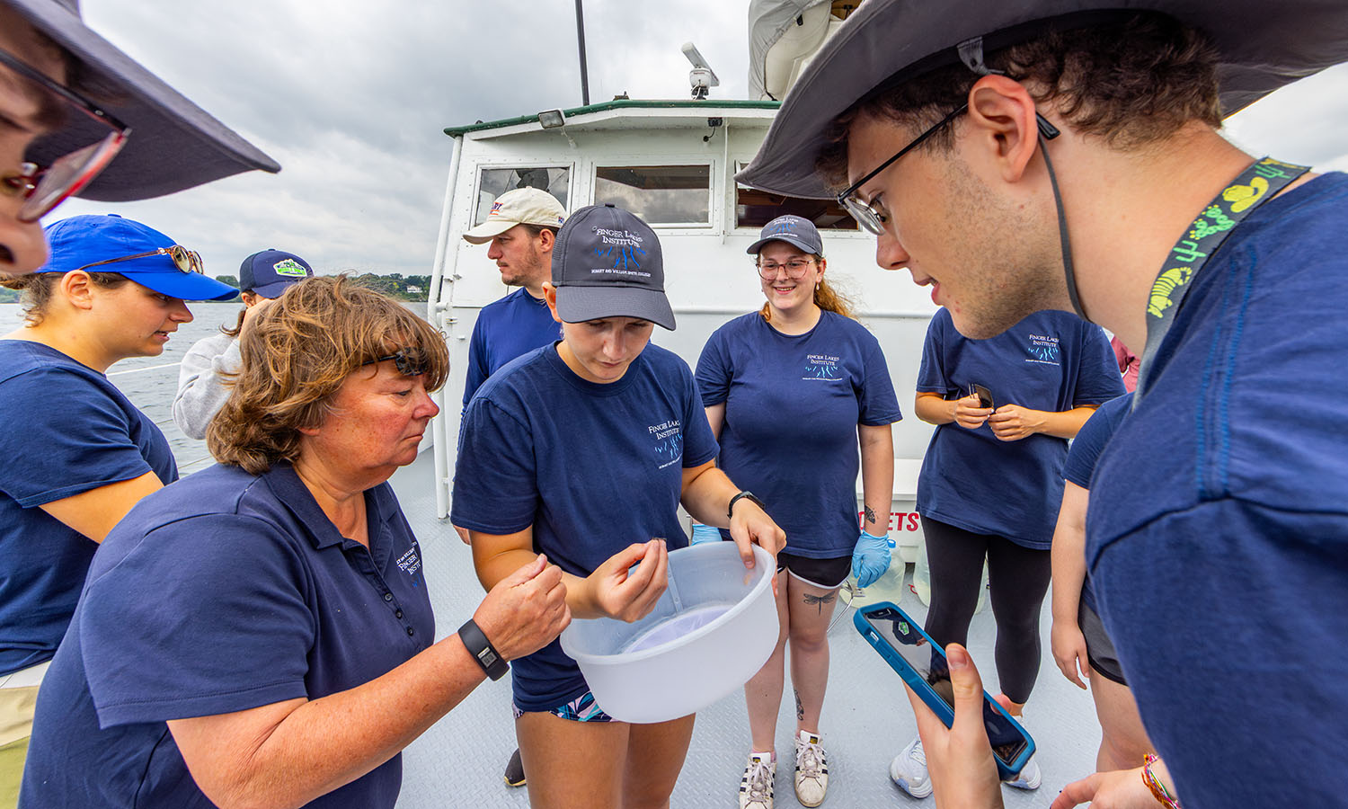 Finger Lakes Institute Director Lisa Cleckner and students pick and sort invertebrates. 