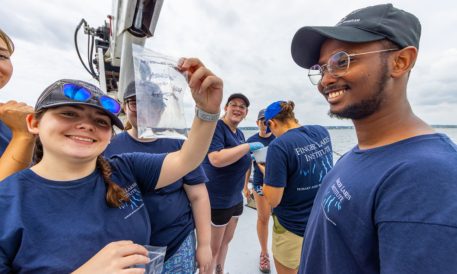 Students pick and sort invertebrates including amphipods and midges from Seneca Lake sediment samples.