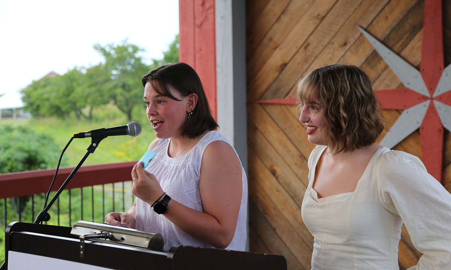 Laura Thérien ’26 and Hazel Brown ’28 speak at Seneca Review’s literary event at Two Goats Brewing. 
