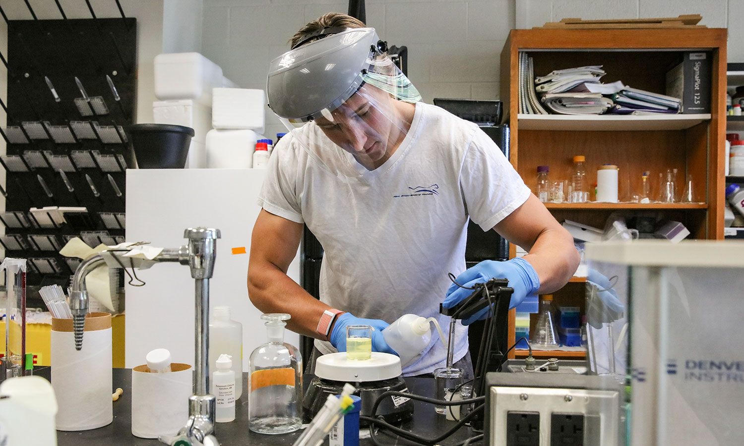 In the lab of Professor of  Chemistry Kristin Slade, Alec Robitaille '21 worked on creating more cell-like conditions for enzymes than just a buffer in 2020.