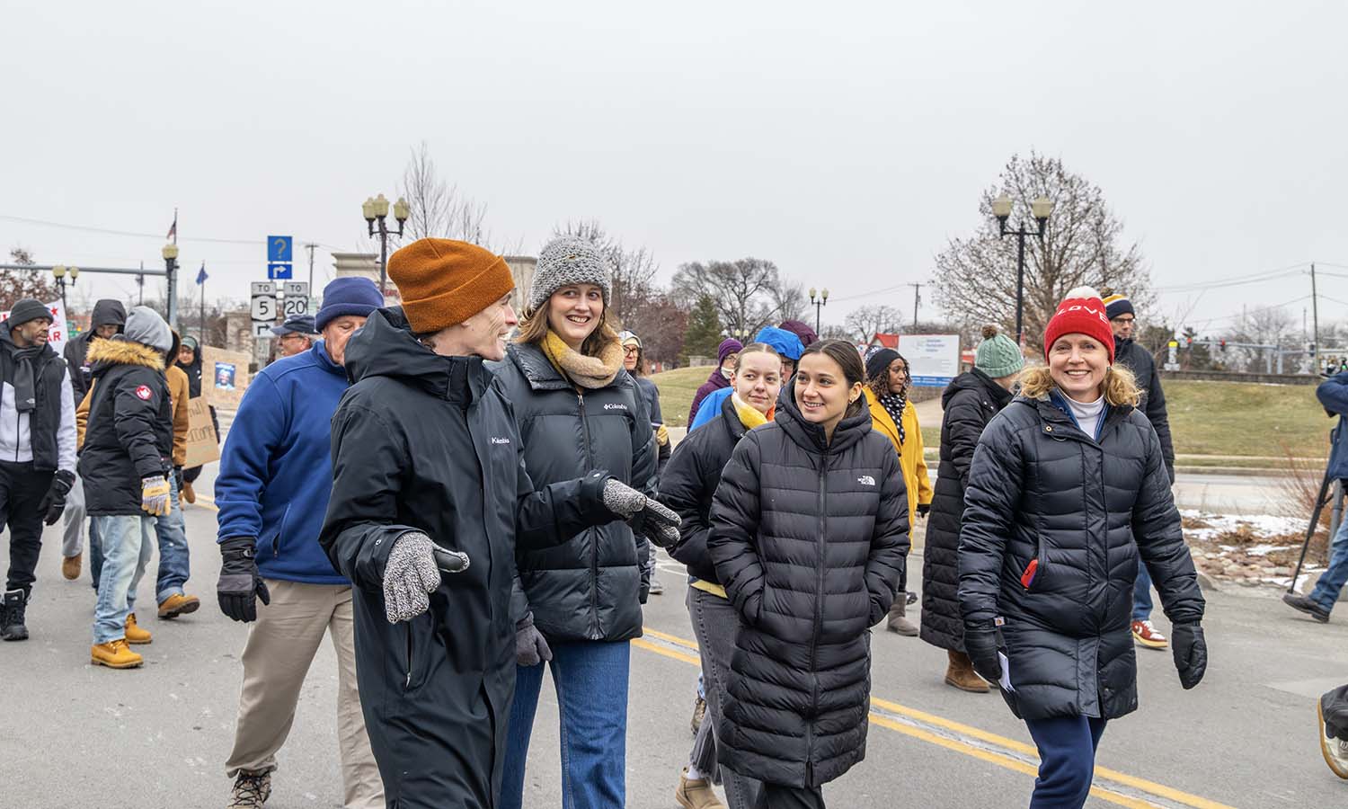 Director of Student Success and Retention Peter Budmen '15, MAT '16, Executive Director of the Center for Community Engagement and Service and students walk down Exchange Street.
