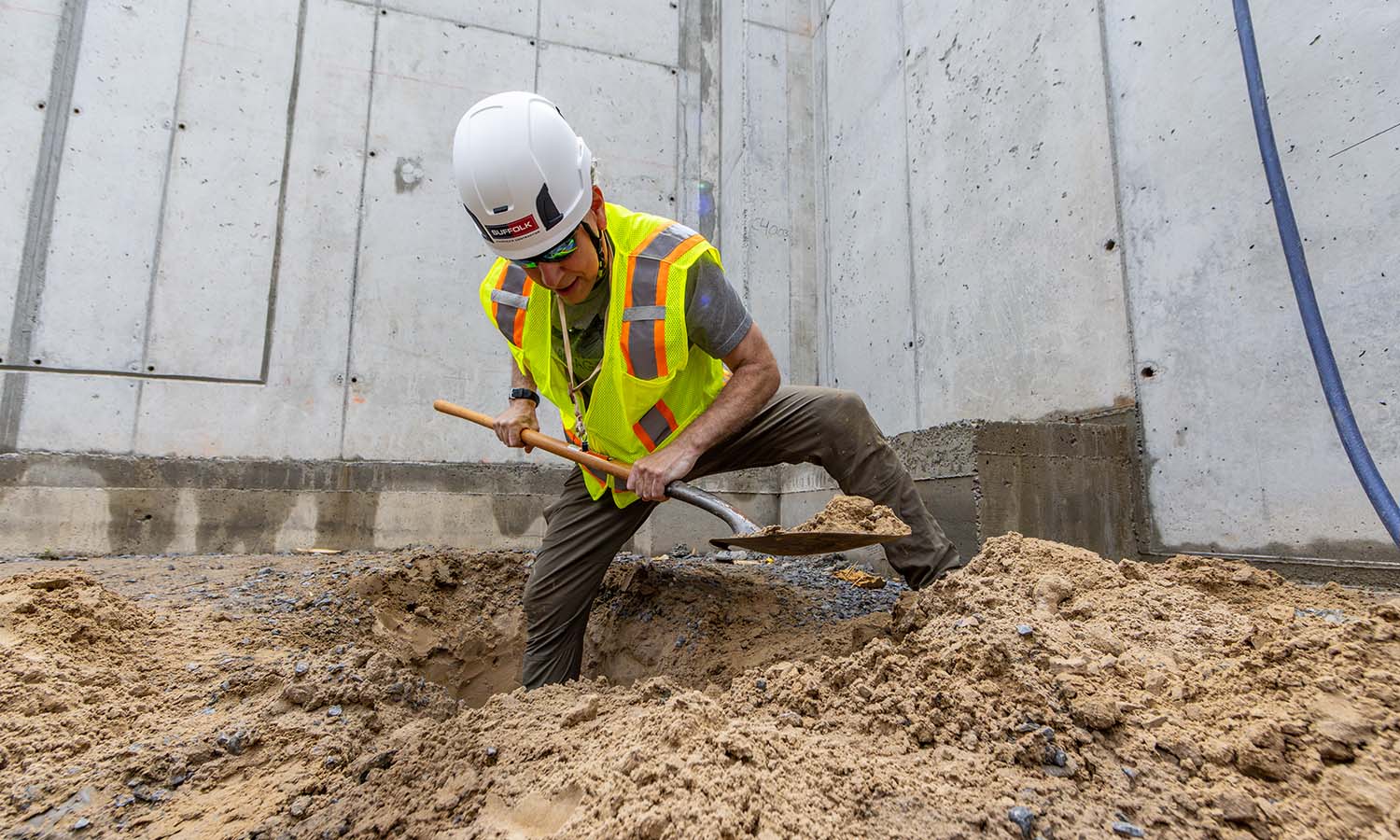 Associate Professor of Geoscience David Finkelstein digs for samples under the Fish Center for the Sciences.