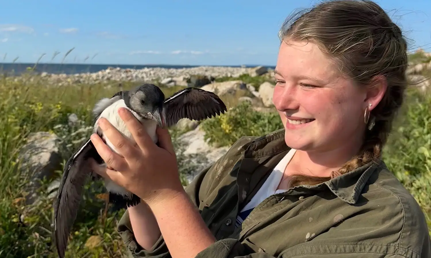 Liz Walker '27 holds a seabird