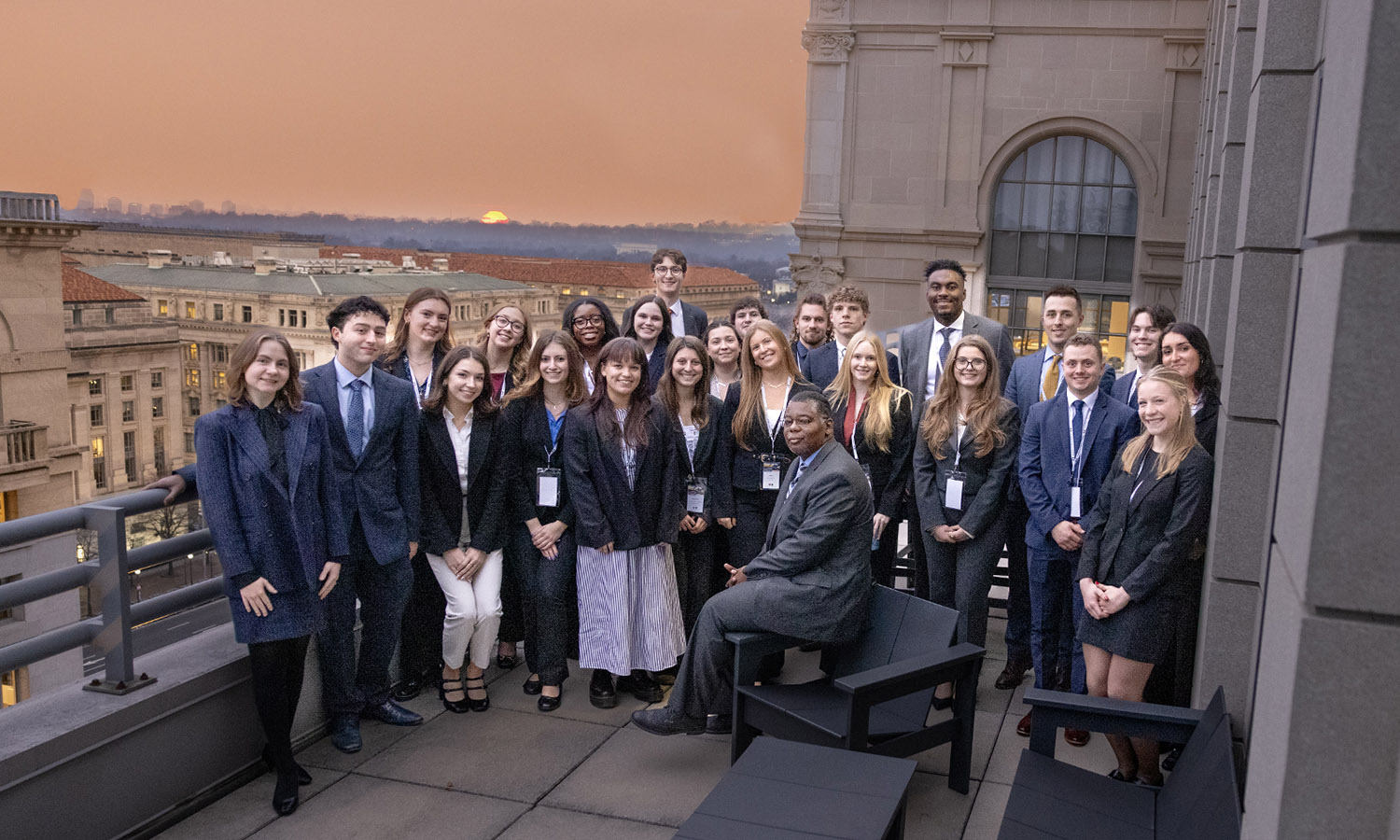 Associate Professor of Political Science DeWayne Lucas and students pose for a group photo while on the roof of FGS Global in Washington, D.C., hosted by Griffin Reiner '24.