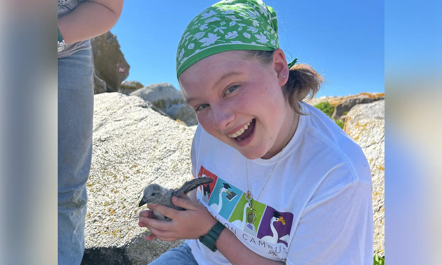 Liz Walker '28 holds a Razorbill chick on Matinicus Rock.