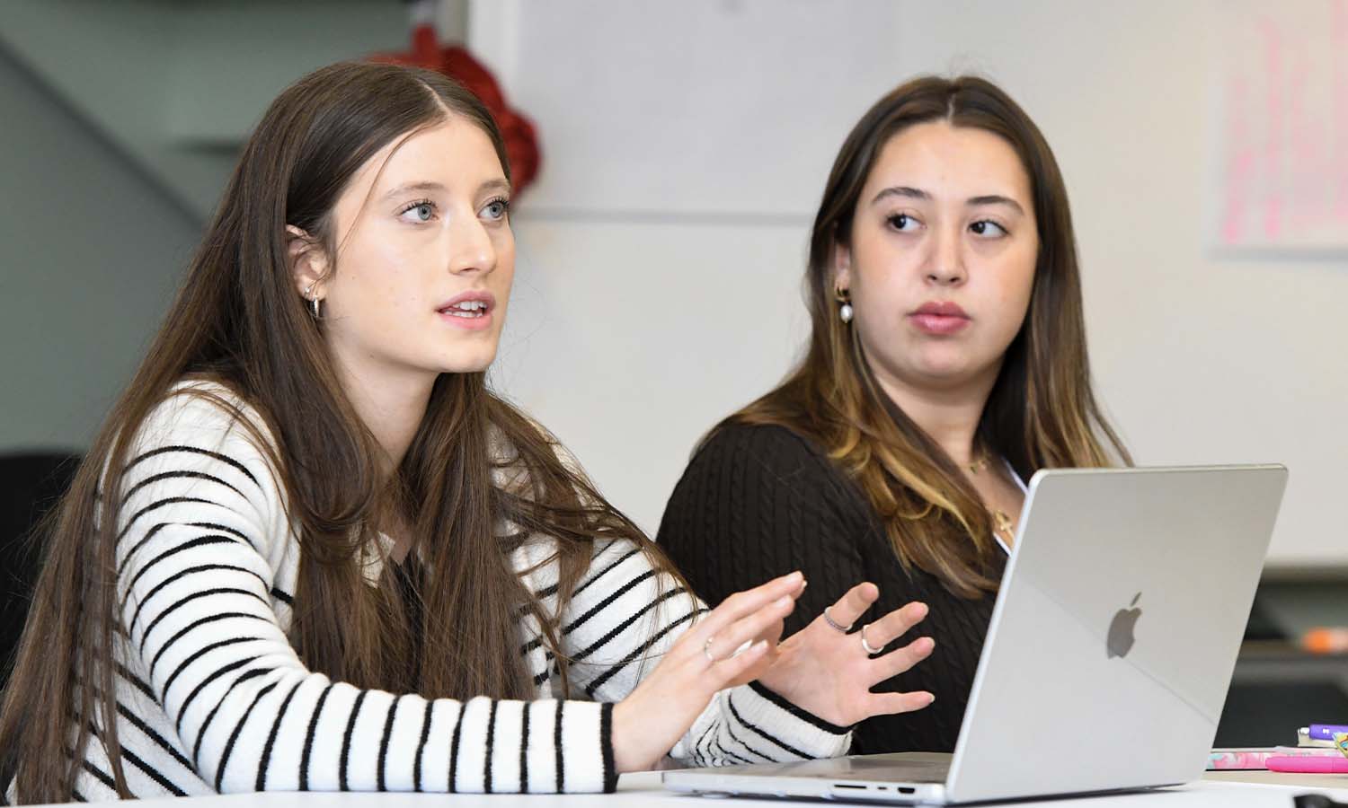 Haley Ross '29 and Jacqueline Connolly '27 respond to Riewerts' presentation.