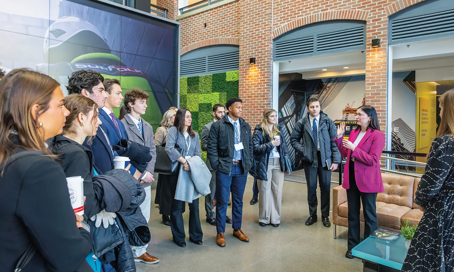 Kathleen Gearan ’21 leads HWS students on a tour of Suffolk Construction where she serves as a marketing coordinator.