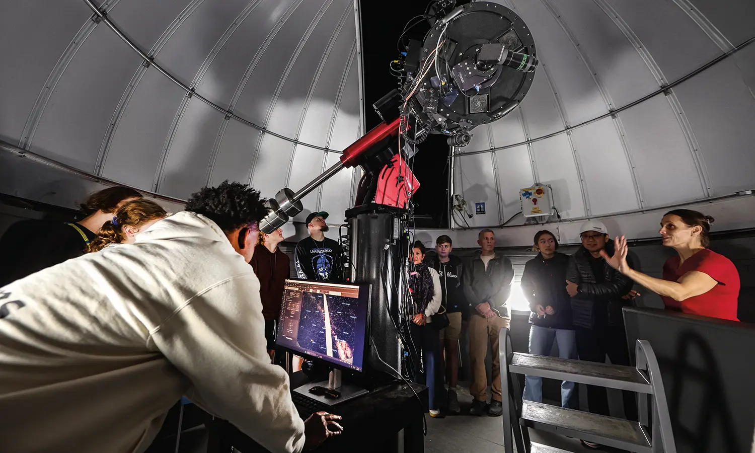 Associate Professor of Physics Leslie Hebb speaks to students and their families at the Richard S. Perkin Observatory open house.