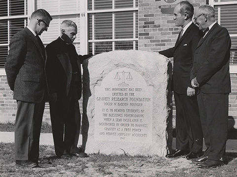 Monument in 1961 erected by the Gravity Research Foundation. Roger W. Babson, founder of Foundation, and Louis B. Hirshson shown.