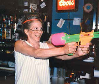Ma aiming a water gun in the Side Show, undated.