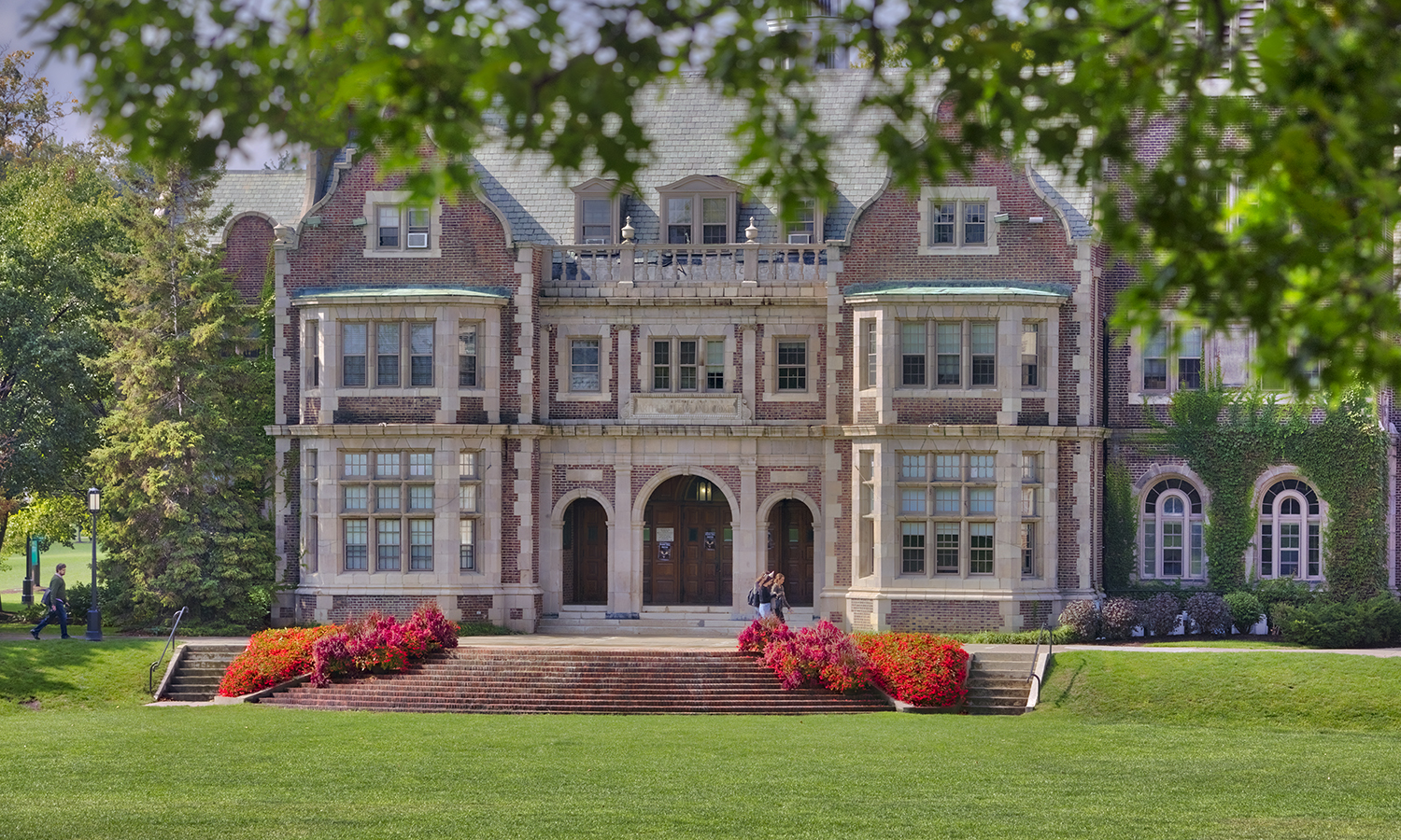 Students walk by Coxe