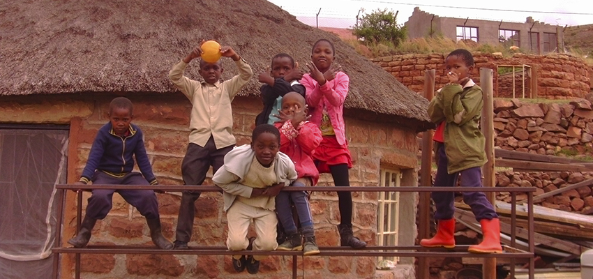 Shanelle France ’11 captures a photo of children, she calls her own, in Ha Sekake village.